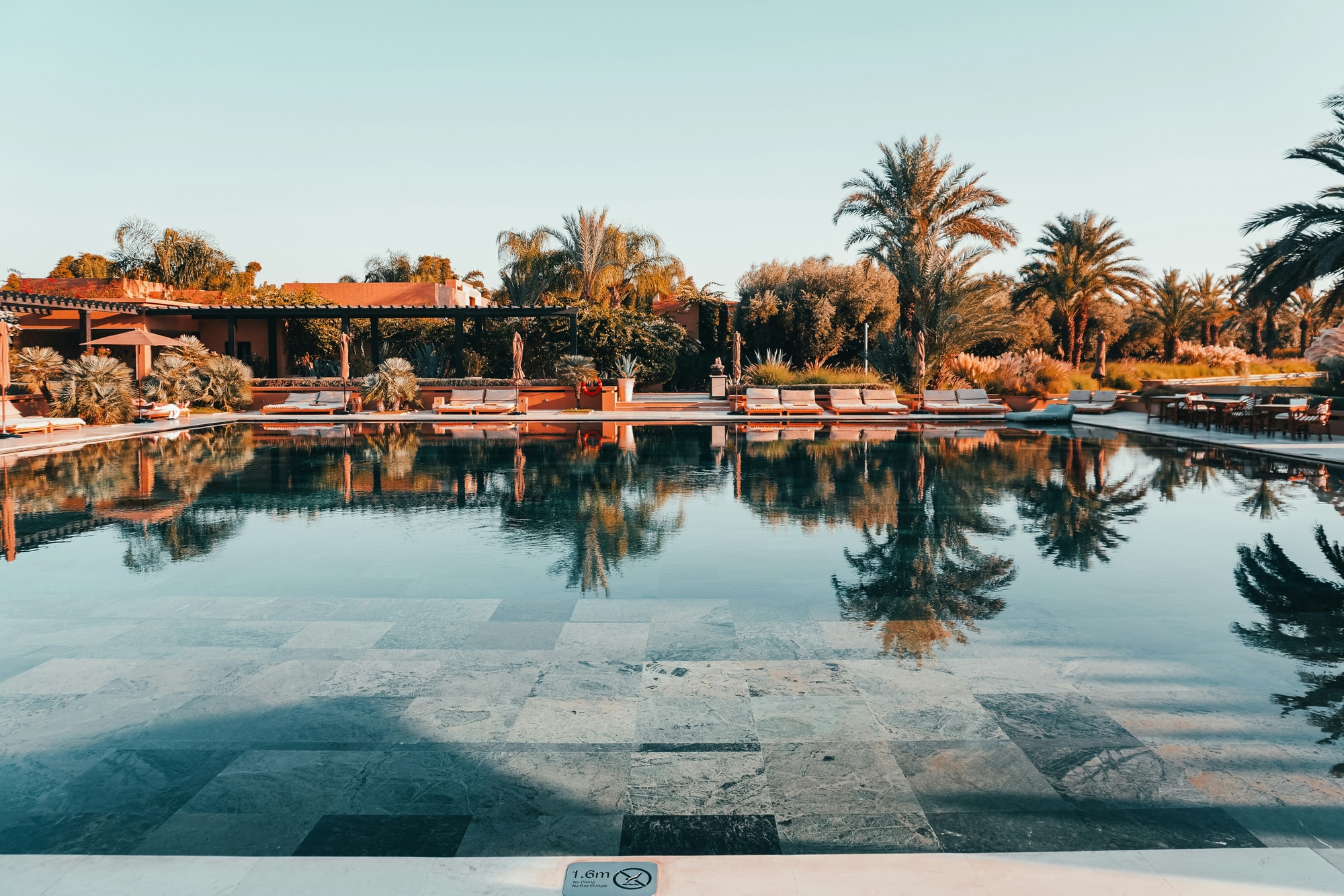 Marrakech, Morocco — a palm-fringed pool at a desert oasis estate