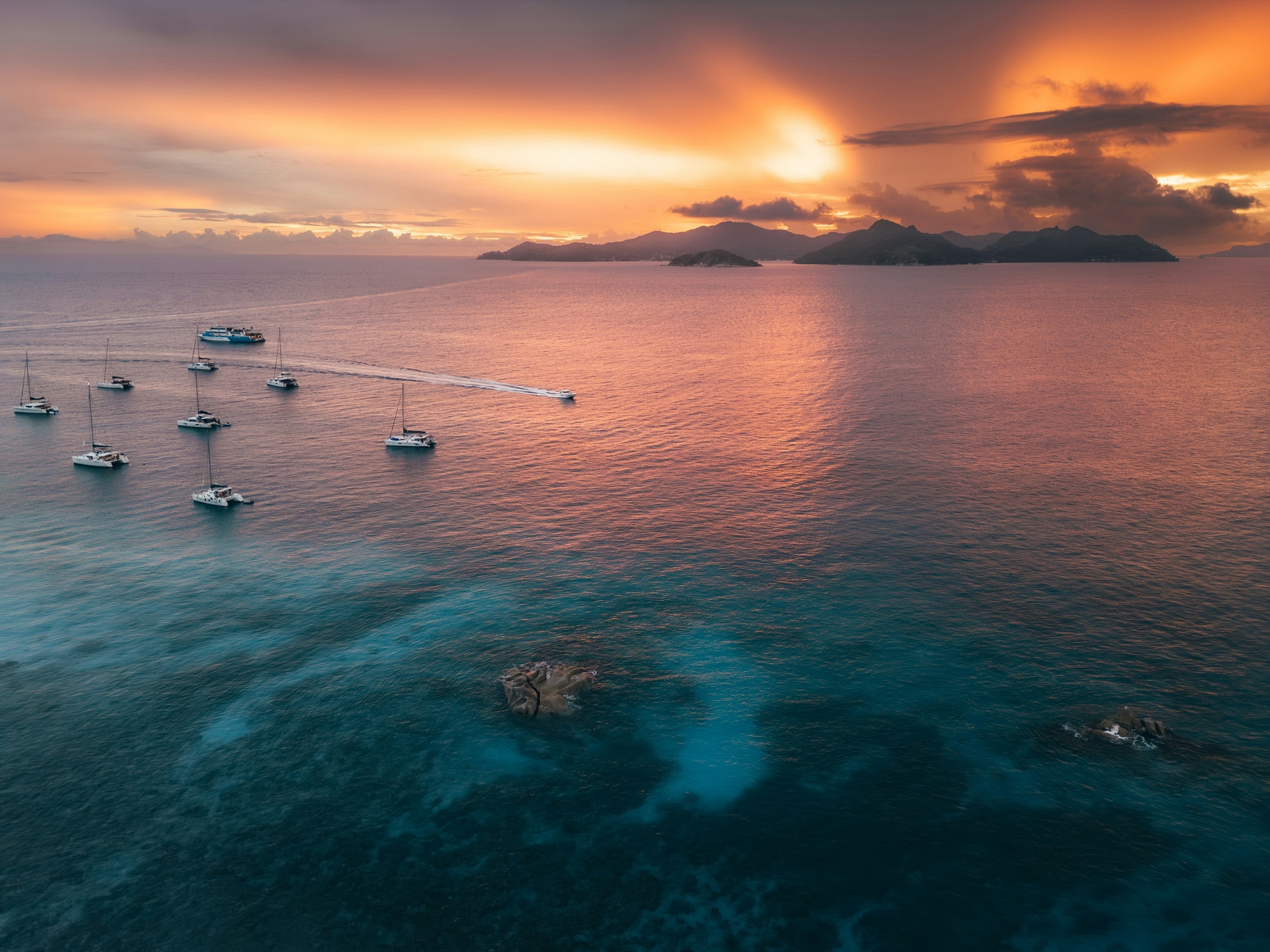 La Digue, Seychelles — catamarans at sunset off La Digue