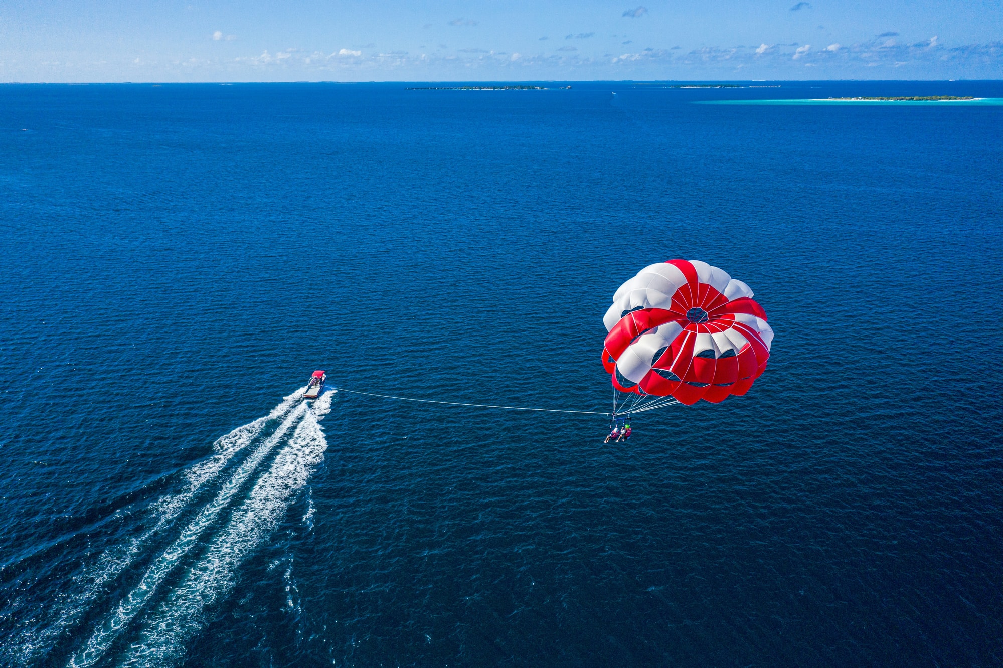 North Malé Atoll, Maldives — parasailing above the crystal lagoons of the Malé Atoll