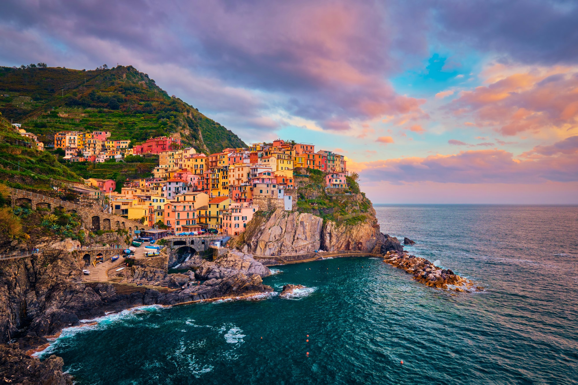 Manarola, Cinque Terre — watching the last light catch the pastel houses above the rocks