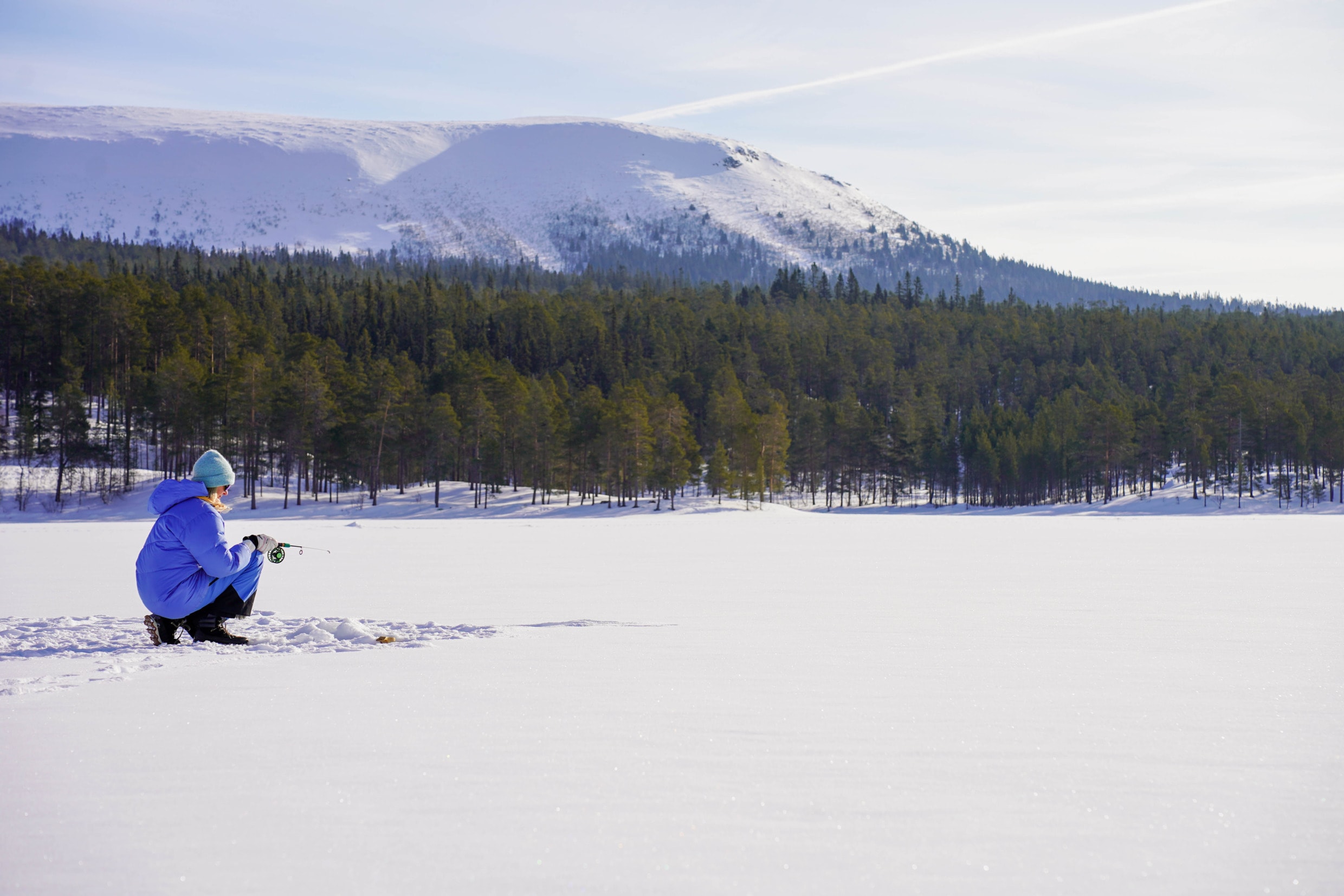 Idre, Dalarna, Sweden — ice fishing on a frozen lake in the Dalarna highlands